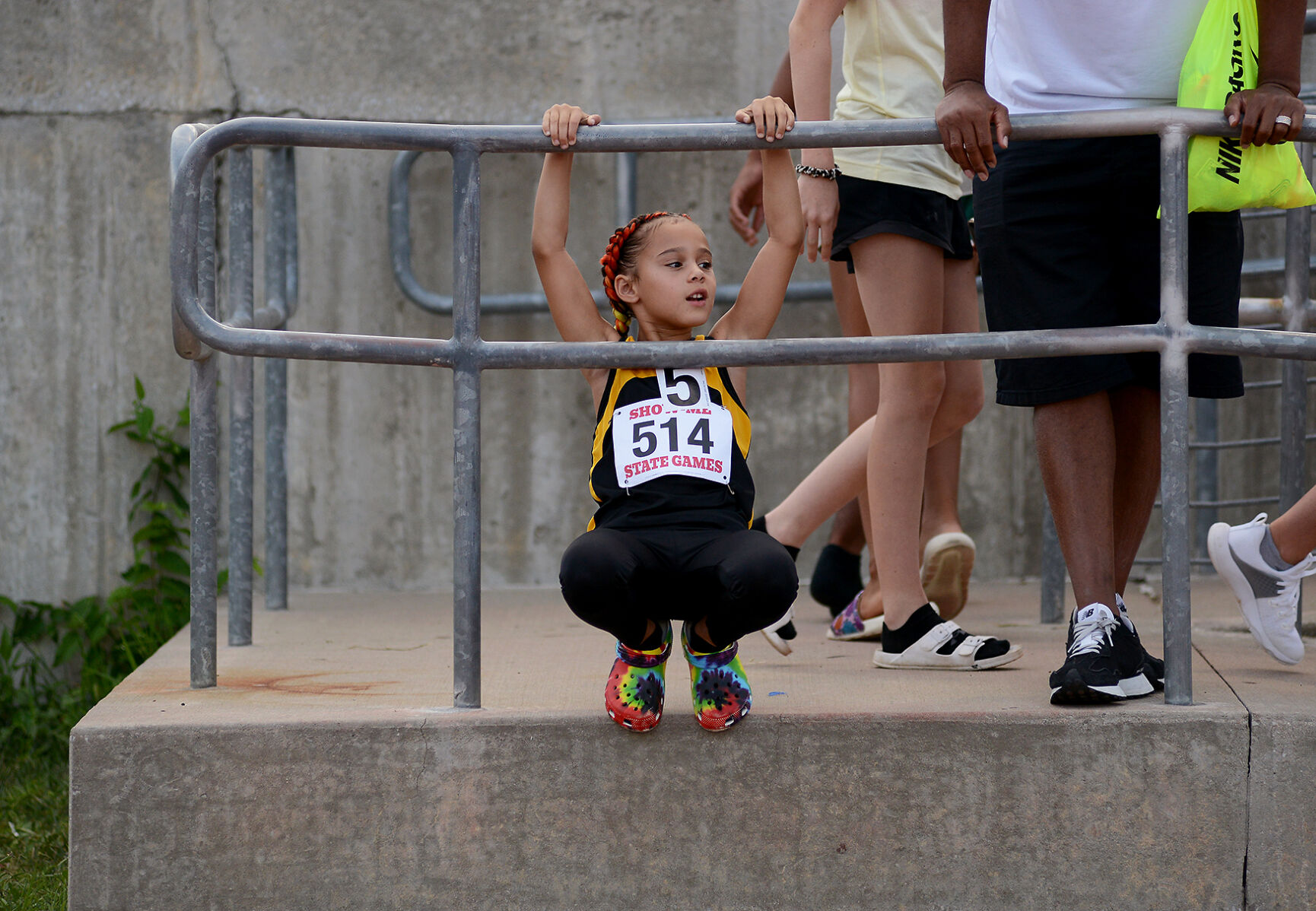 Aria Newbill hangs out on the sidelines to watch other events